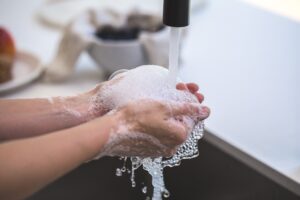 Pic of person washing their hands with soap and water